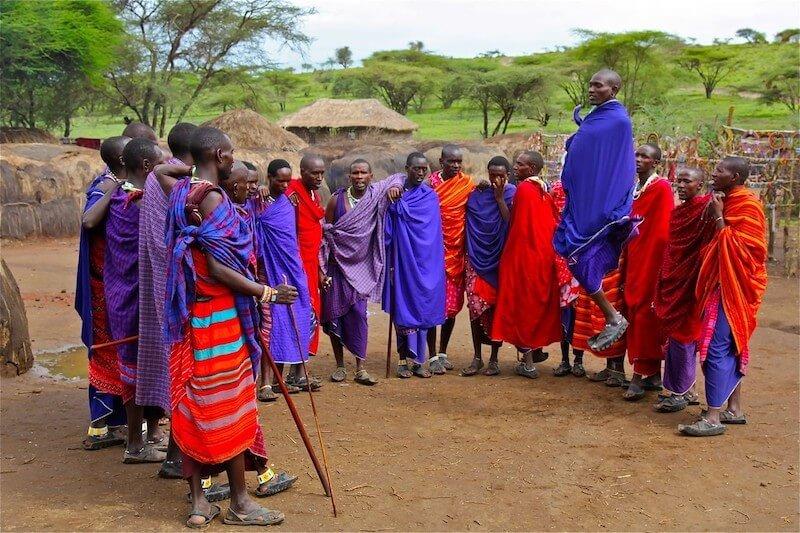 Maasai warriors in traditional red shuka robes during a cultural ceremony